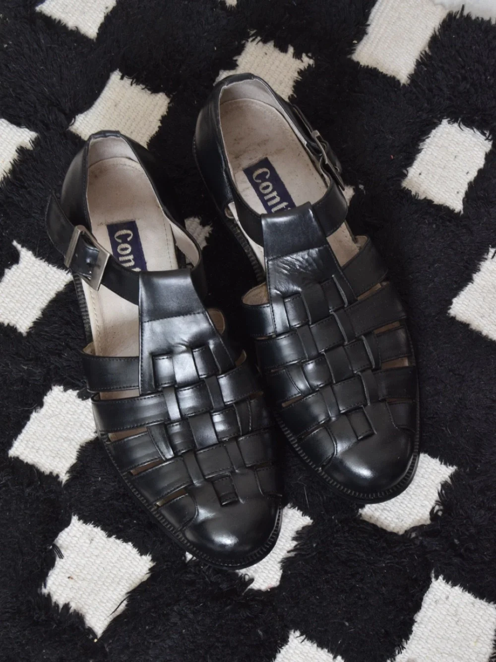 Black leather woven sandals / huaraches with buckle detail.